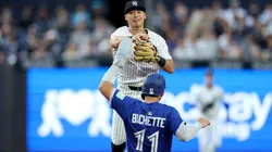 Anthony Volpe #11 of the New York Yankees turns the double play as Bo Bichette #11 of the Toronto Blue Jays.
