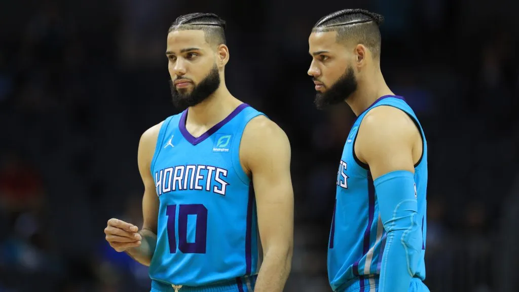 Caleb Martin #10 and Cody Martin #11 of the Charlotte Hornets talk during a game. (Streeter Lecka/Getty Images)