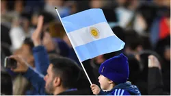 A fan of Argentina holds a flag