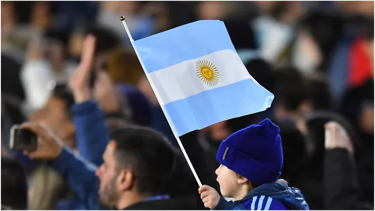 A fan of Argentina holds a flag