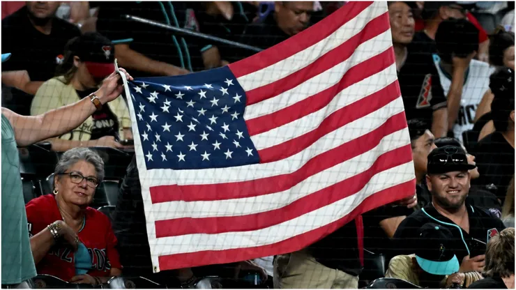 Fans hold up an American Flag