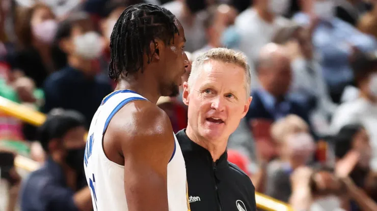 Jonathan Kuminga #00 of the Golden State Warriors speaks with head coach Steve Kerr.