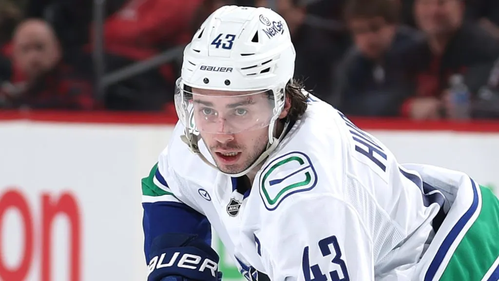 Quinn Hughes #43 of the Canucks takes the puck against the NJ Devils. (Photo by Elsa/Getty Images)