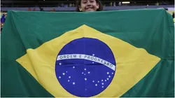 A young fan of Brazil cheers with the Brazilian flag
