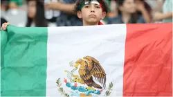 A fan holds up the flag of Mexico