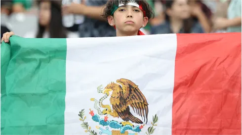 A fan holds up the flag of Mexico