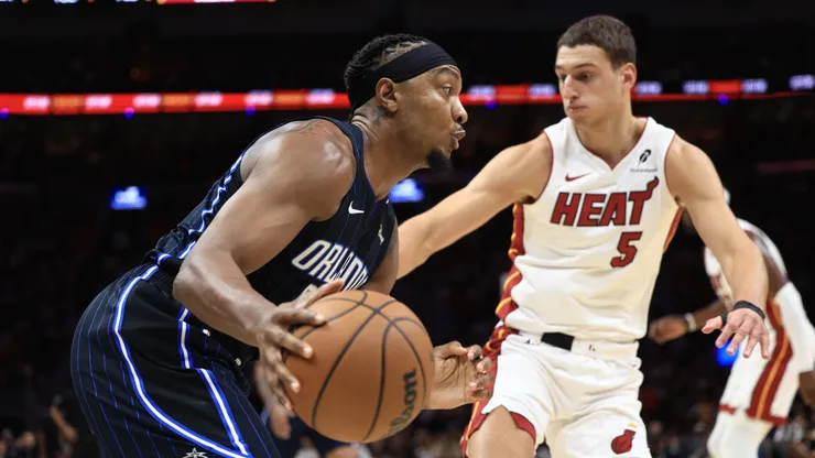 Wendell Carter Jr. #34 of the Orlando Magic controls the ball ahead of Nikola Jovic #5 of the Miami Heat.