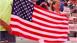 Fans hold an American flag