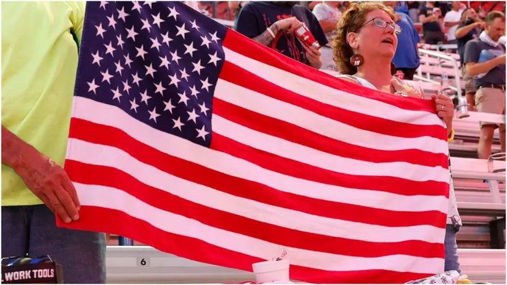 Fans hold an American flag
