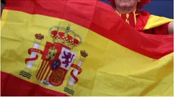 A fan of Spain holds up a flag