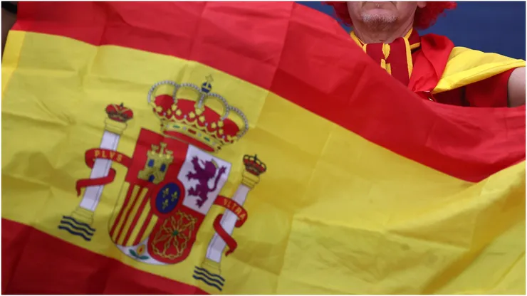 A fan of Spain holds up a flag