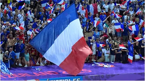 Fans of France celebrate victory by waving their national flag
