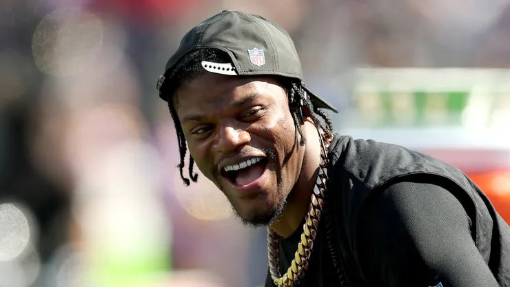 Quarterback Lamar Jackson #8 of the Baltimore Ravens laughs on the sidelines.