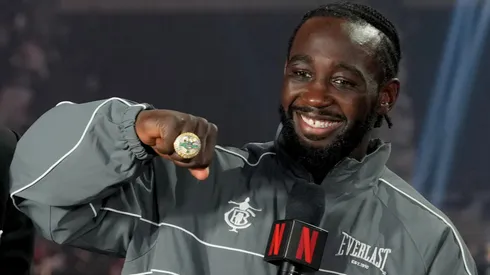 Terence Crawford poses with his undisputed super middleweight title ring and belt.