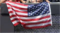 Fans hold an American flag