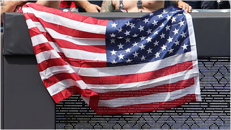 Fans hold an American flag
