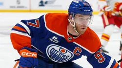 Connor McDavid #97 of the Edmonton Oilers skates past Kevin Bahl #7 of the Calgary Flames.