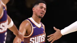 Devin Booker #1 of the Phoenix Suns reacts after hitting a free throw.