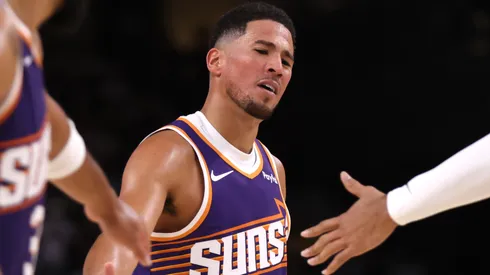 Devin Booker #1 of the Phoenix Suns reacts after hitting a free throw.