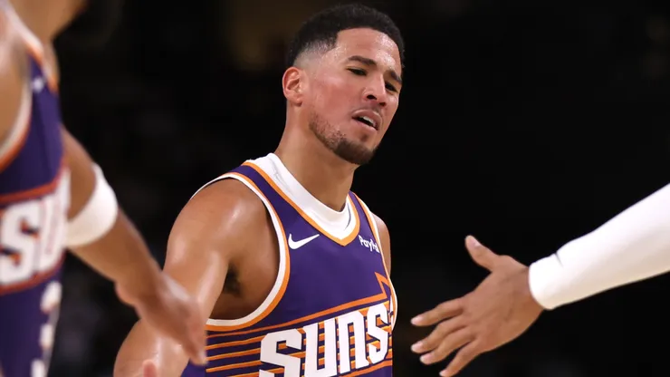 Devin Booker #1 of the Phoenix Suns reacts after hitting a free throw.