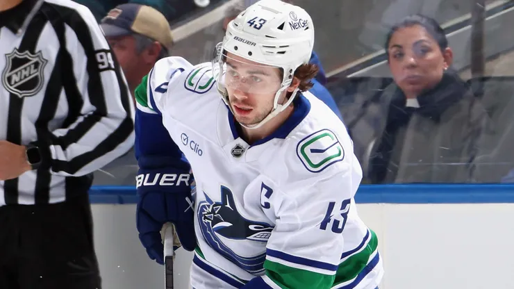 Quinn Hughes #43 of the Vancouver Canucks skates in an NHL game.