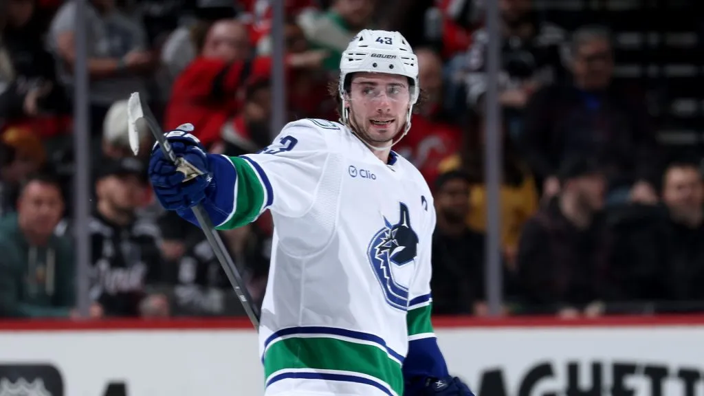 Quinn Hughes #43 of the Canucks directs his teammates in an NHL game.  Elsa/Getty Images