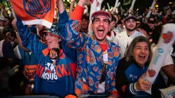 Stelios Yamalis (C) and other New York Knicks fans cheer during the first quarter in 2025.