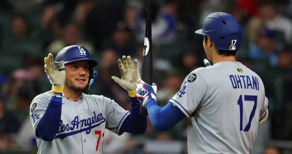 Miguel Rojas reacts with Shohei Ohtani after hitting a solo homer