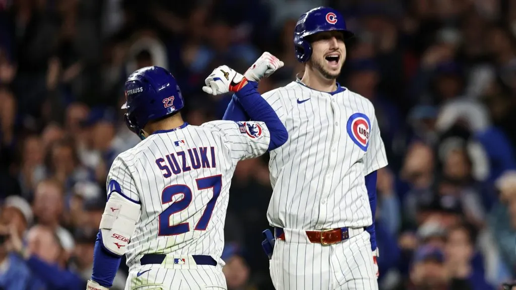 Seiya Suzuki #27 and Kyle Tucker #30 of the Cubs celebrate after Tucker hit a home run against the Brewers. Geoff Stellfox/Getty Images