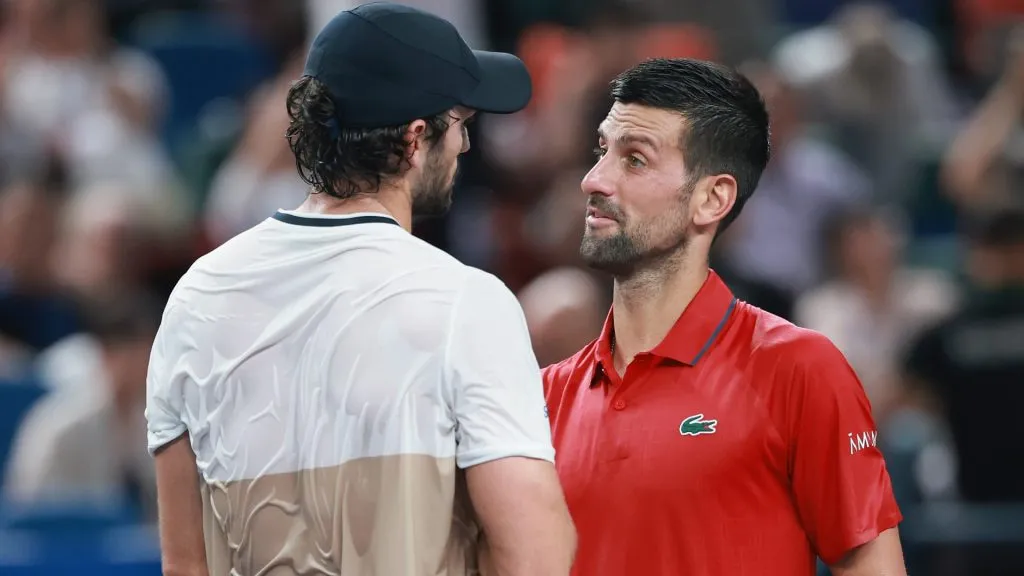 Novak Djokovic speaks with Valentin Vacherot at the net. (Lintao Zhang/Getty Images)