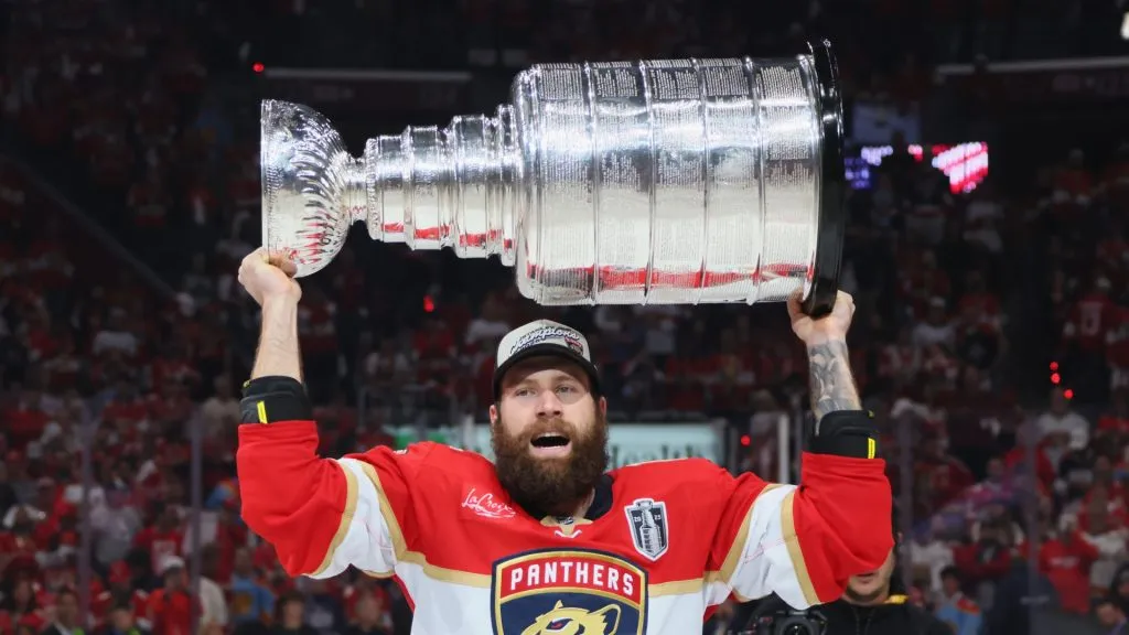 Jonah Gadjovich lifting the Stanley Cup.