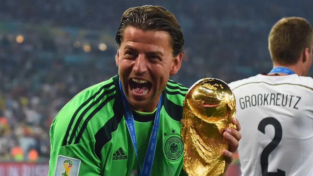 Roman Weidenfeller celebrates with the trophy after the 2014 World Cup final.