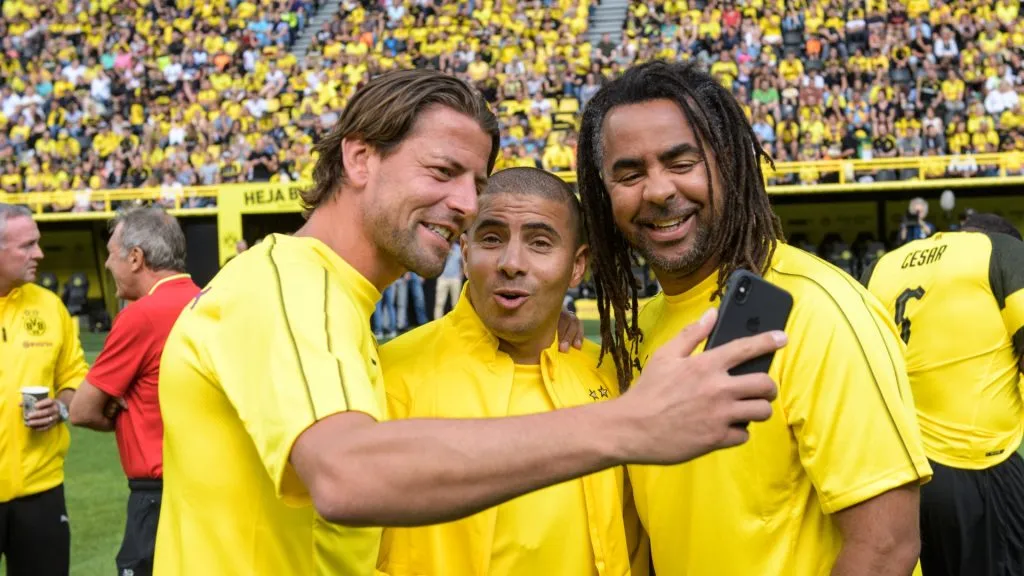 Roman Weidenfeller, Mohamed Zidan and Patrick Owomoyela (L-R) take a photo before a friendly of legends.