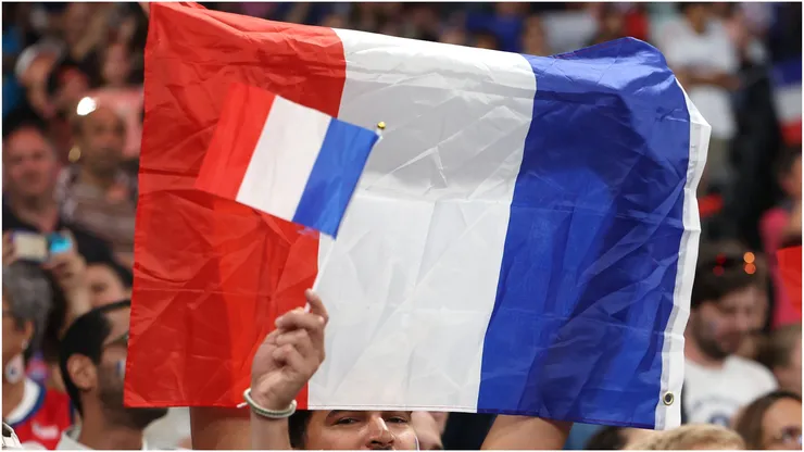 Fans wave a flag of France