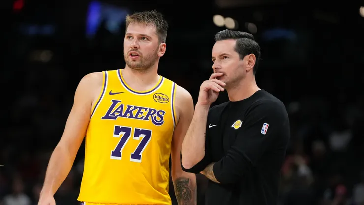 Luka Doncic #77 of the Los Angeles Lakers talks with head coach JJ Redick.