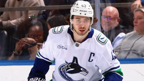 Quinn Hughes #43 of the Vancouver Canucks skates in an NHL game.