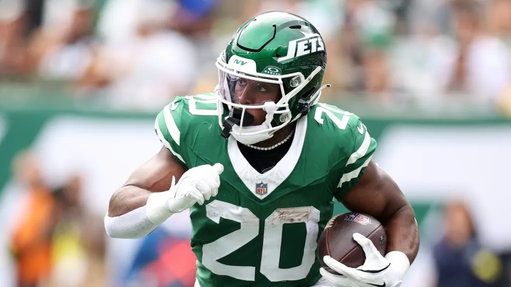 Breece Hall runs with the ball.