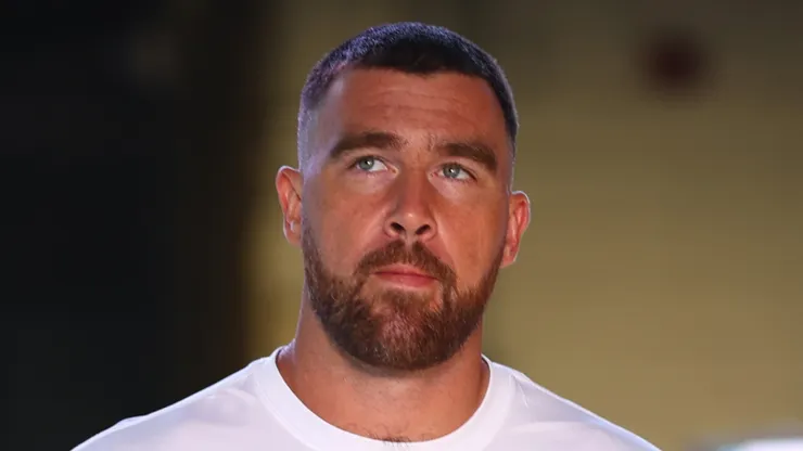 Travis Kelce walking into a stadium.