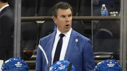 Head coach Mike Sullivan of the New York Rangers tends to the bench during the game.