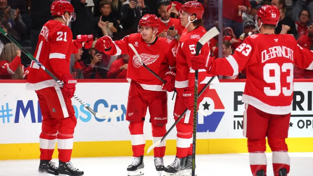 Patrick Kane (#88) celebrates a second-period goal with Red Wings teammates against the Panthers. Gregory Shamus/Getty Images