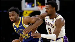 LJ Cryer of the Golden State Warriors controls the ball against Bronny James of the Los Angeles Lakers