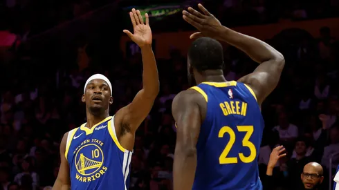 Jimmy Butler III #10 and Draymond Green #23 of the Golden State Warriors high-five.