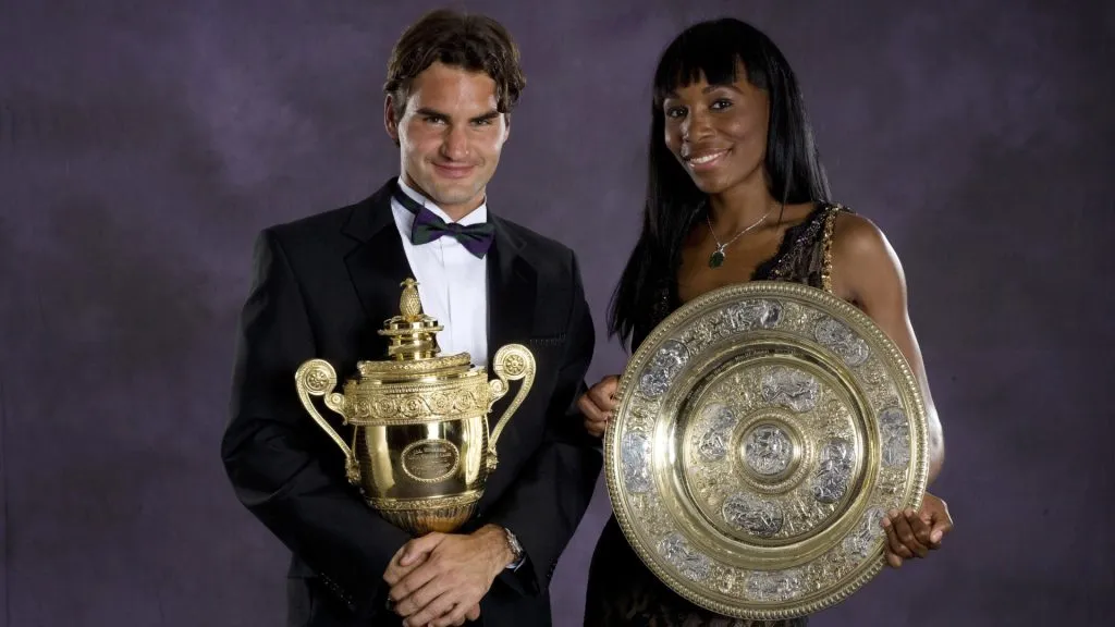 Venus Williams and Roger Federer pose with their 2007 Wimbledon trophies. (Getty Images)