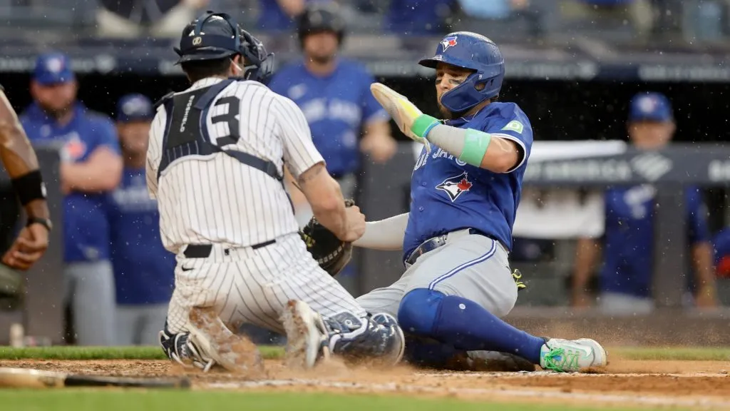 Bo Bichette #11 of the Blue Jays is tagged out at the plate. (Photo by Jim McIsaac/Getty Images)