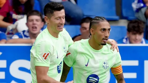 Robert Lewandowski of FC Barcelona celebrates scoring his team's first goal with team mate Raphinha.