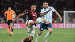 Danilo of Flamengo shoots against Adrian Martinez of Racing Club