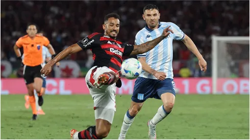 Danilo of Flamengo shoots against Adrian Martinez of Racing Club