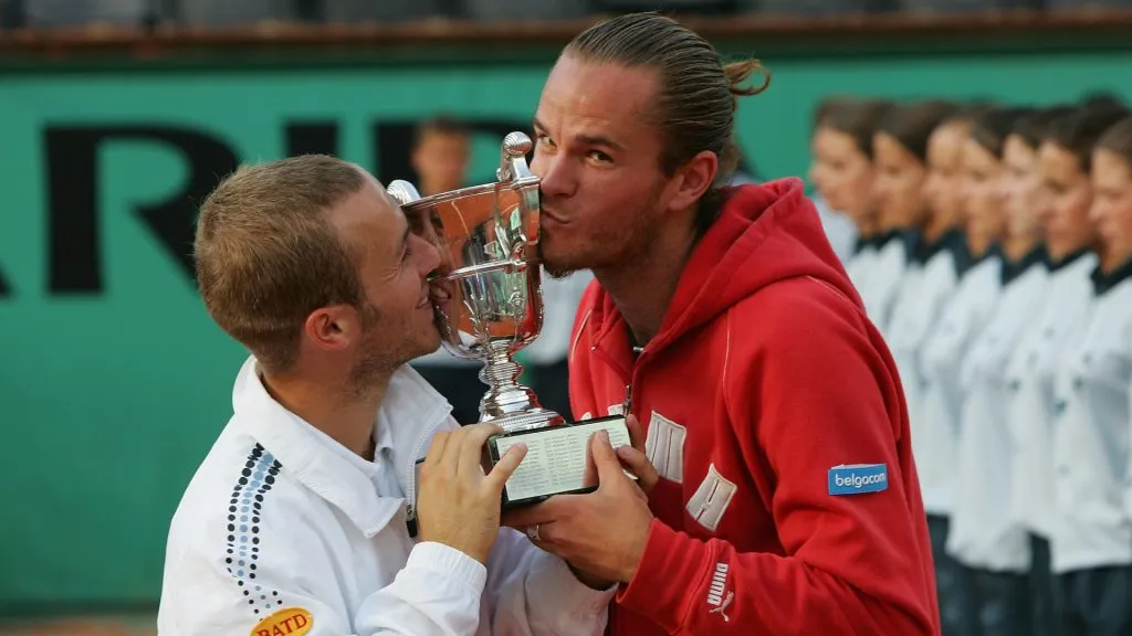 Xavier Malisse and Olivier Rochus kiss the trophy after winning Roland Garros in 2004. (Getty Images)