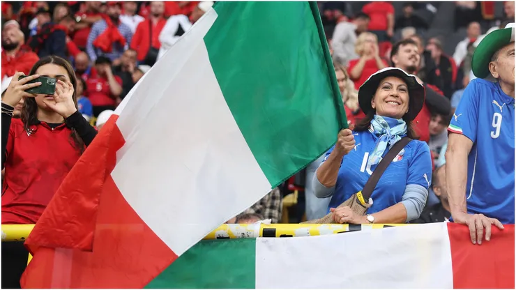 A fan waves the national flag of Italy