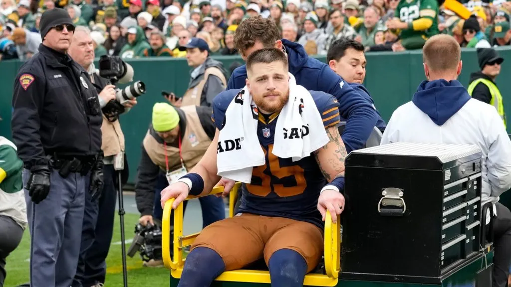 Tucker Kraft helped off the field with an injury against the Panthers.